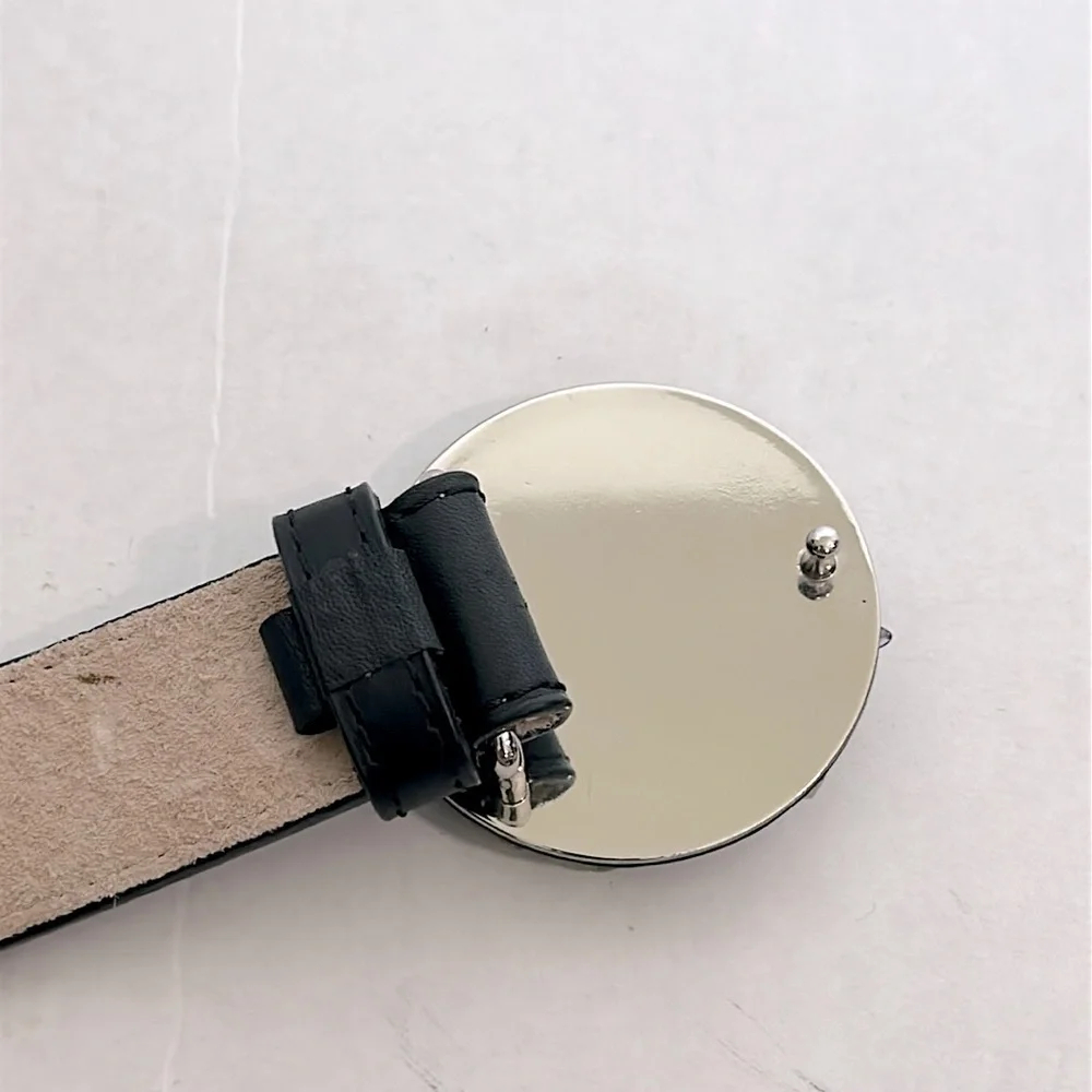Talbots black leather belt with a circular buckle adorned with gemstones large
